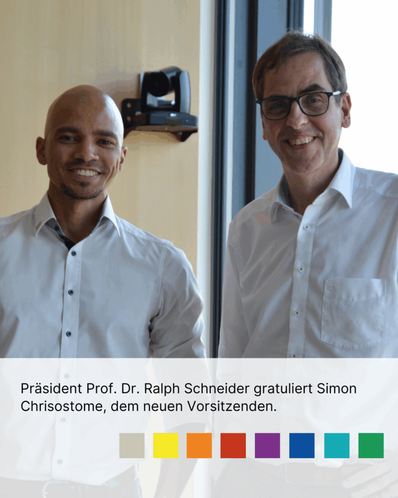 Präsident Prof. Dr. Ralph Schneider gratuliert Simon Chrisostome, dem neuen Vorsitzenden.